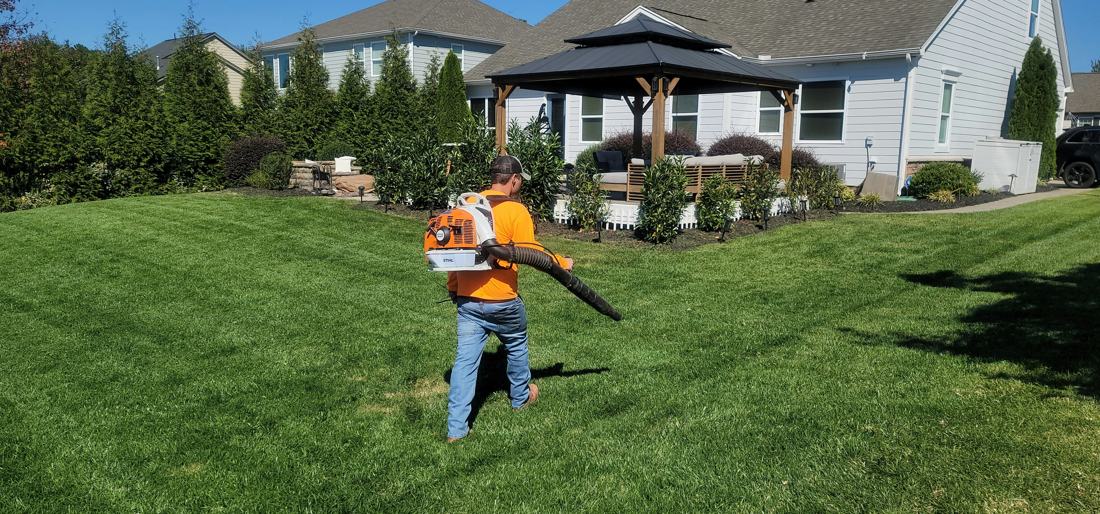 Blowing clippings off a fresh-cut lawn